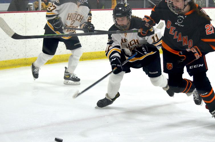 Elle Schweim battles for puck