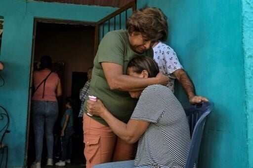 Relatives comfort each other after the death of Victor Alfonzo Bustos, 35, during a protest against Venezuelan President Nicolas Maduro's reelection victory